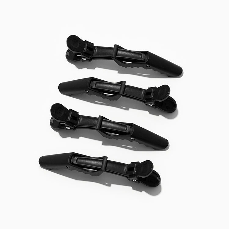 four black crocodile hair clips