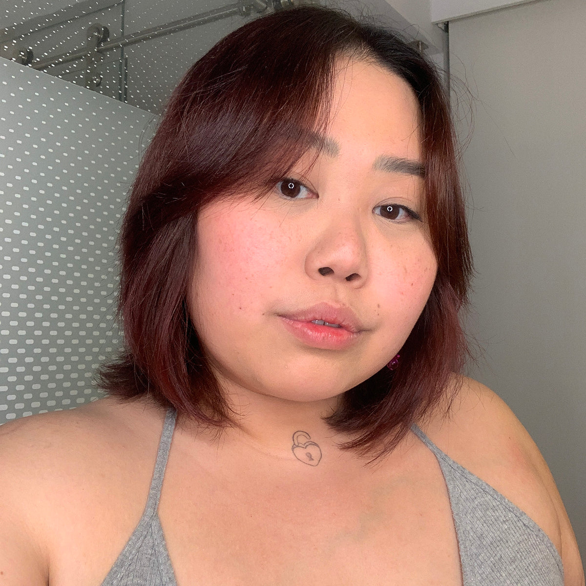 person with rose gold for brown hair color on short dark hair