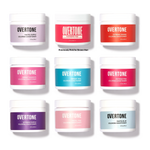 Grid of nine Overtone coloring conditioner jars in various shades including pastel purple, vibrant pink, extreme orange, vibrant magenta, vibrant teal, extreme pink, extreme purple, pastel pink, and pastel blue, each in a white jar with colored labels matching the hair dye shade