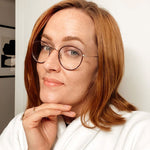 light brown hair color on person with shoulder-length hair wearing glasses