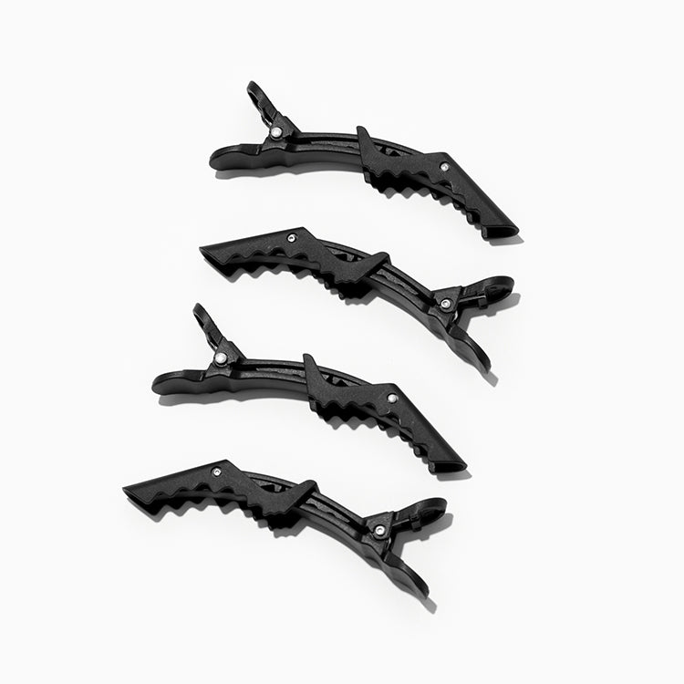 four black crocodile hair clips on the side
