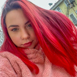 person with extreme red hair color on pre-lightened long hair