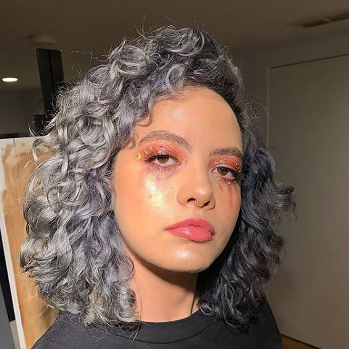 charcoal gray hair color on person with shoulder, curly length pre-lightened hair