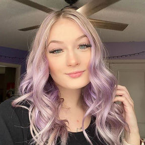 person with pastel purple hair color on shoulder length pre-lightened hair