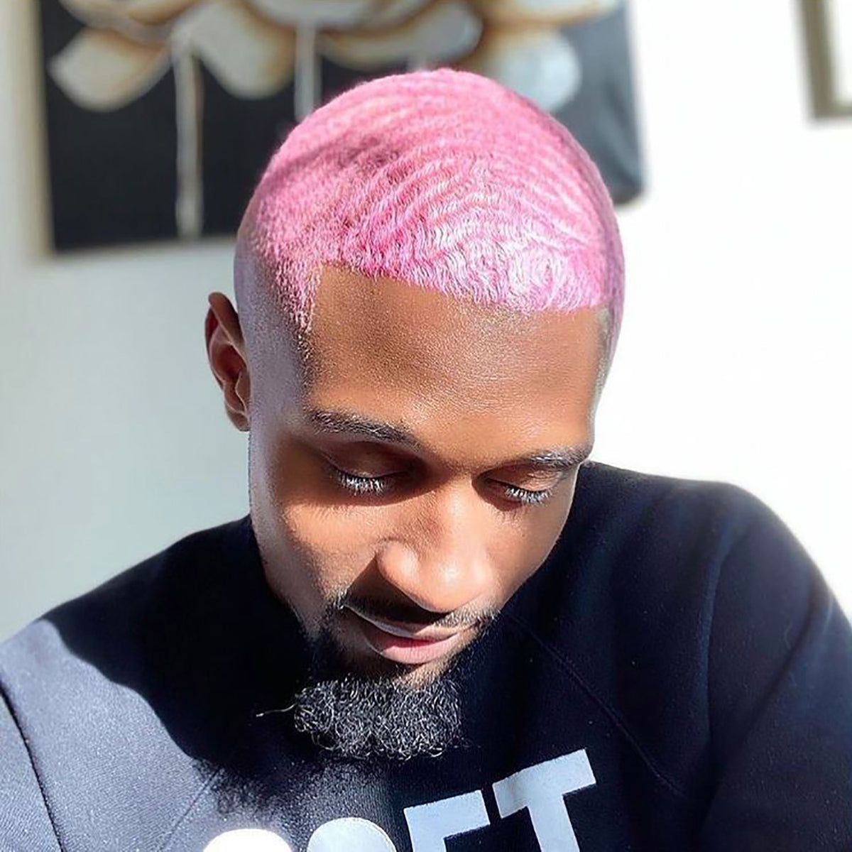 person with pastel pink hair color on pre-lightened buzz cut