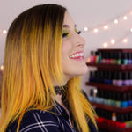 person with dark roots and medium length yellow gold pre-lightened hair color with plaid shirt