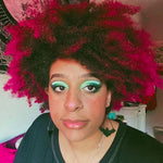 person with dip dye bright magenta hair color on natural coily hair