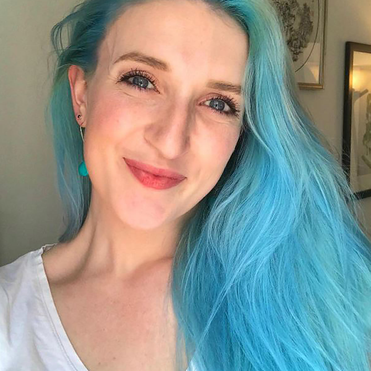 person with long aquamarine hair color on long pre-lightened hair
